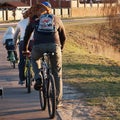 Family ride bikes with cat